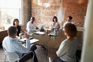 Group Of Businesspeople Meeting for collaboration In Modern Boardroom